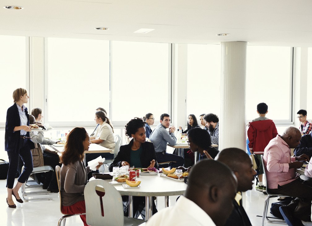 Diverse Unesco staff dining and socializing in a bright, modern cafeteria on the seventh floor.