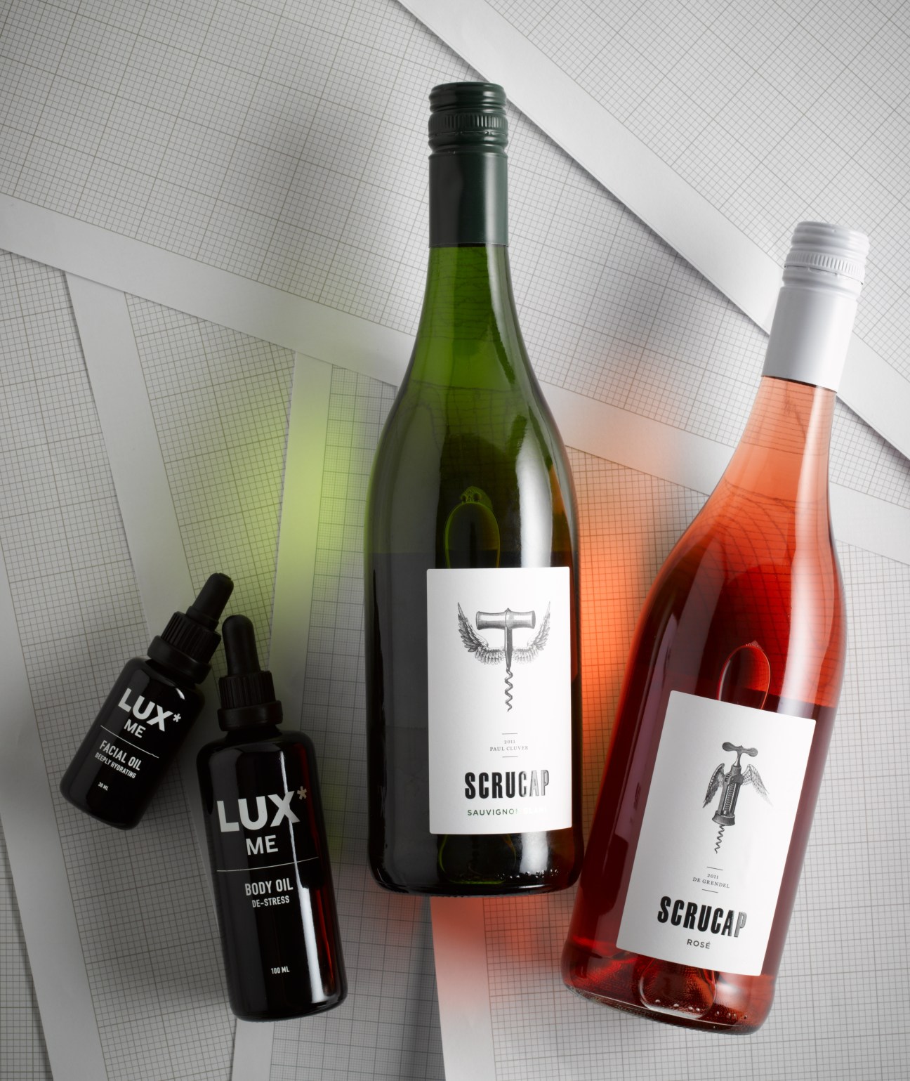 Lux* body oils and Scrucap wines including facial oil, body oil, and white and rosé bottles.