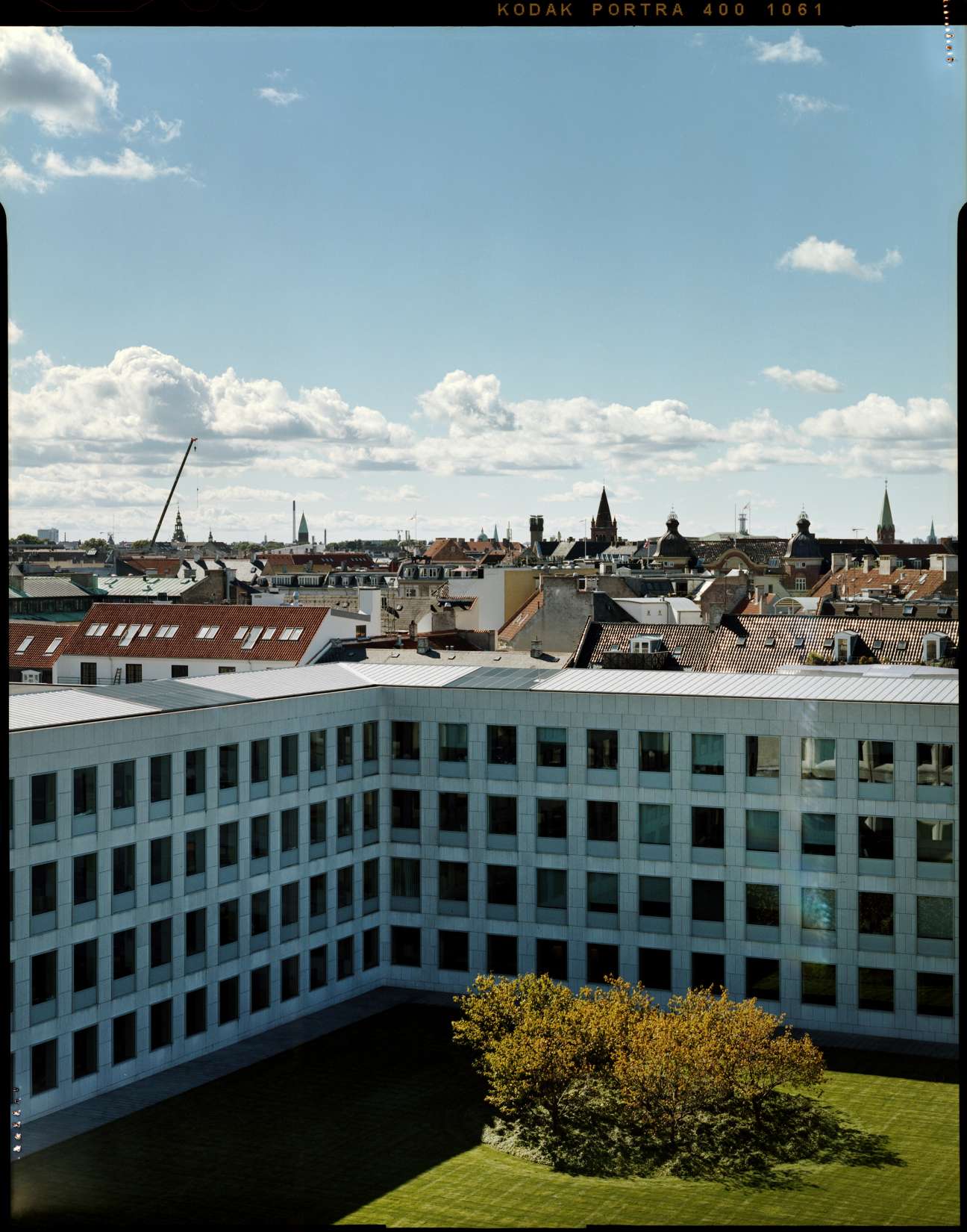 Maersk headquarters 2005 extension with Copenhagen skyline and central courtyard visible beyond.