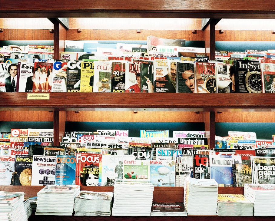 Wooden shelves displaying hundreds of magazines and publications at Fog City News newsstand in San Francisco.
