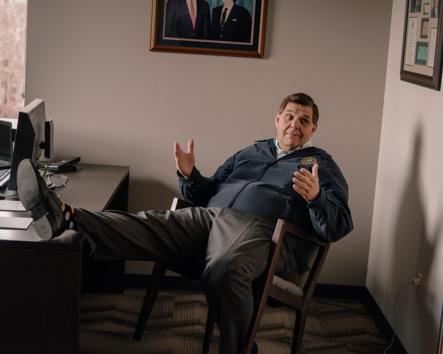 Jim Brulte, chair of the California Republican party, reclines in an office chair with feet up on desk.