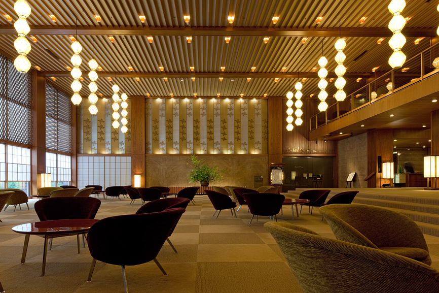 Hotel Okura's 1960s lobby featuring pendant lights, modernist furniture, and geometric flooring design.