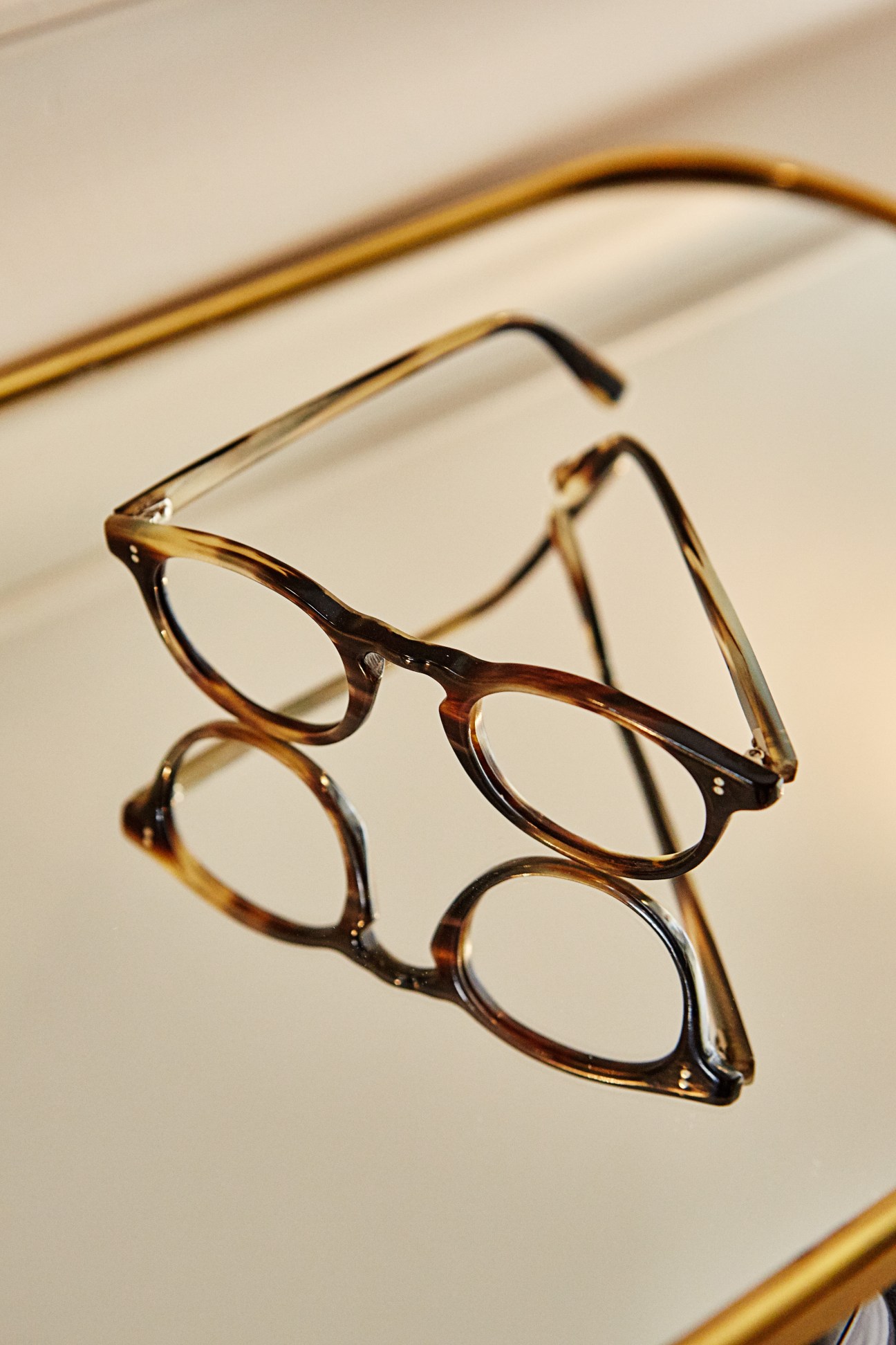 Two pairs of tortoiseshell acetate eyeglasses with clear lenses displayed on a neutral background.