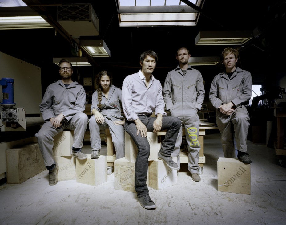Five members of the Council Design team sit on wooden furniture in their workshop.