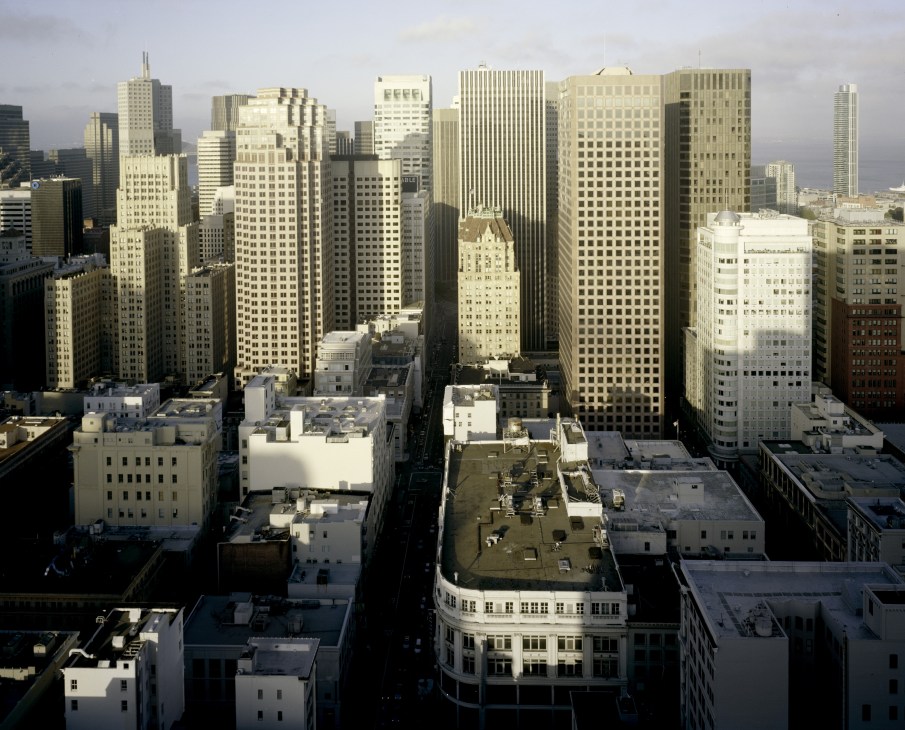 San Francisco downtown skyline showing densely packed high-rise buildings and skyscrapers under cloudy sky.