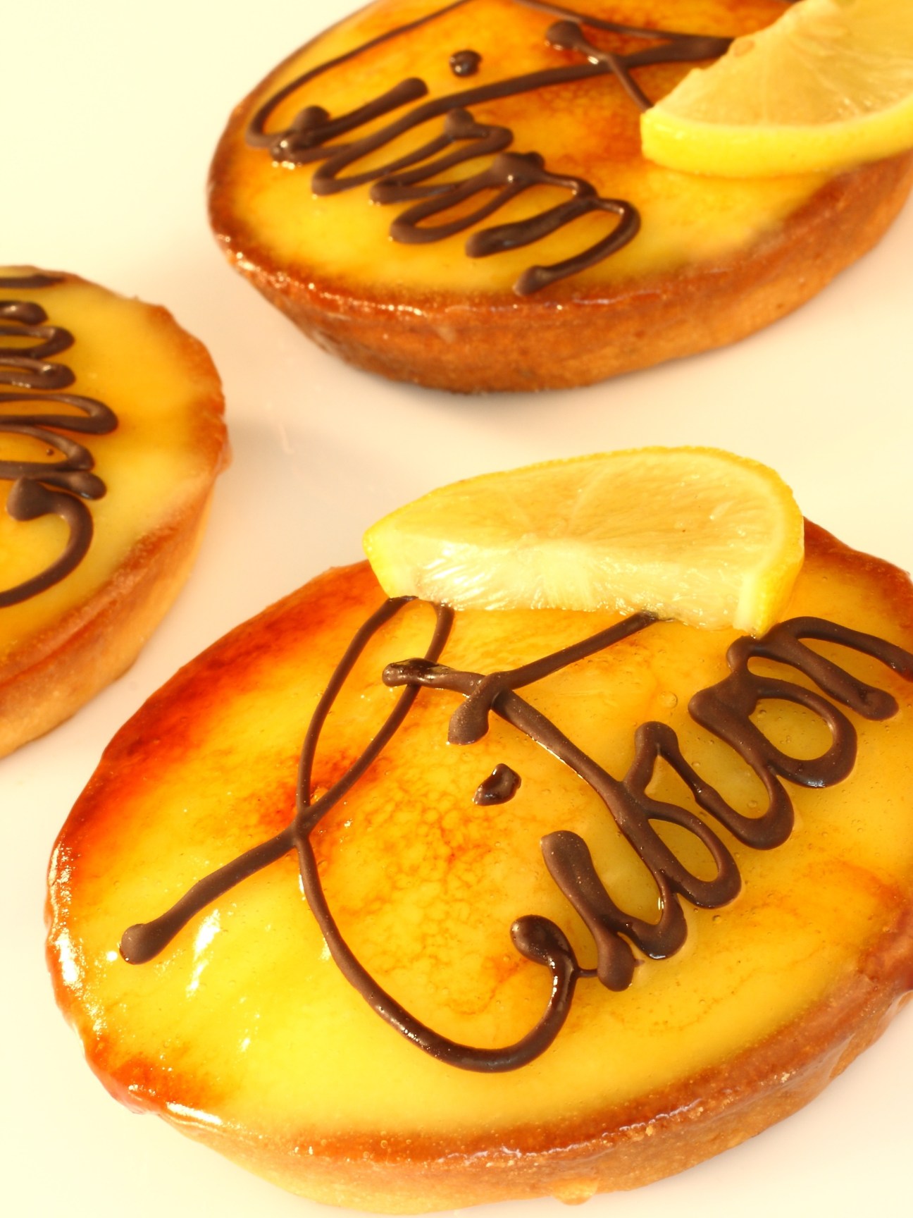 Lemon-topped pastries with chocolate drizzle decoration from L'Opera French patisserie in Delhi.