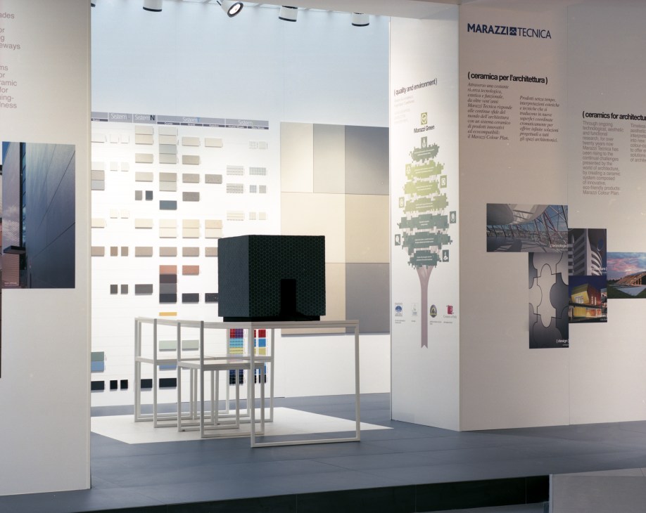 Marazzi's 400 sq m showroom displaying ceramic material samples and architectural photography on white walls.