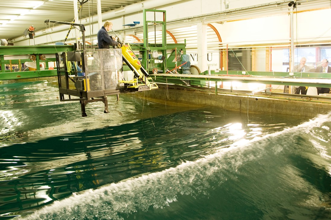 Interior of Marintek's testing facility with an 80-meter pool containing simulated waves and towing equipment.