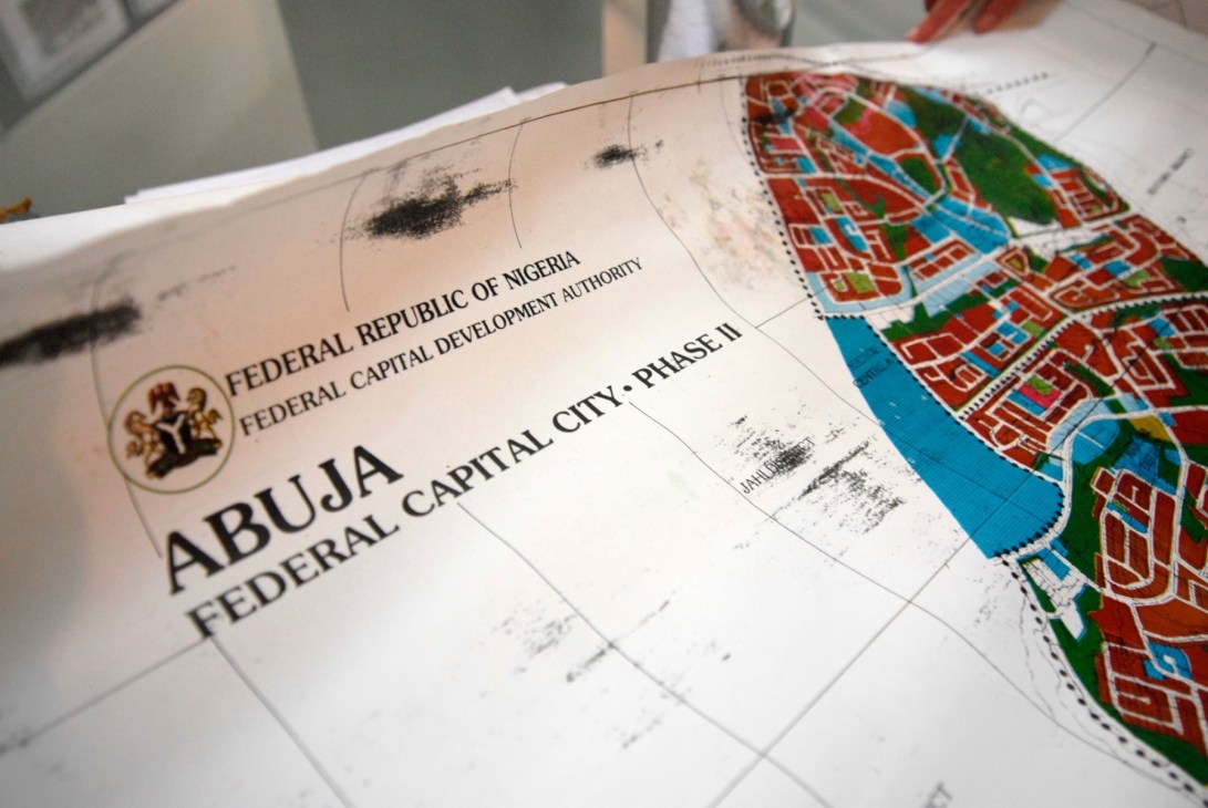 Official masterplan documents for Abuja's Federal Capital City Phase II showing colored urban layout maps.