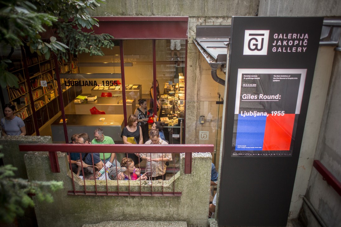 Jakopic Gallery storefront displaying Giles Round exhibition with visitors inside and promotional signage.