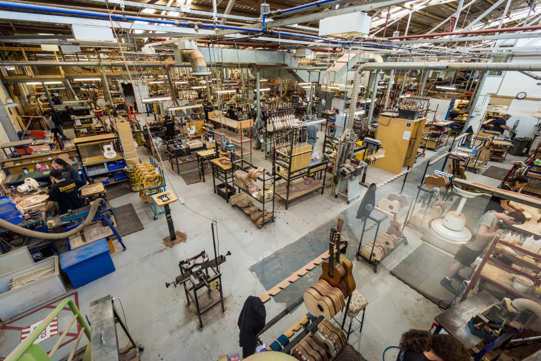 Overhead view of Maton's Melbourne guitar manufacturing factory showing workstations, equipment, and guitars in various stages of production.