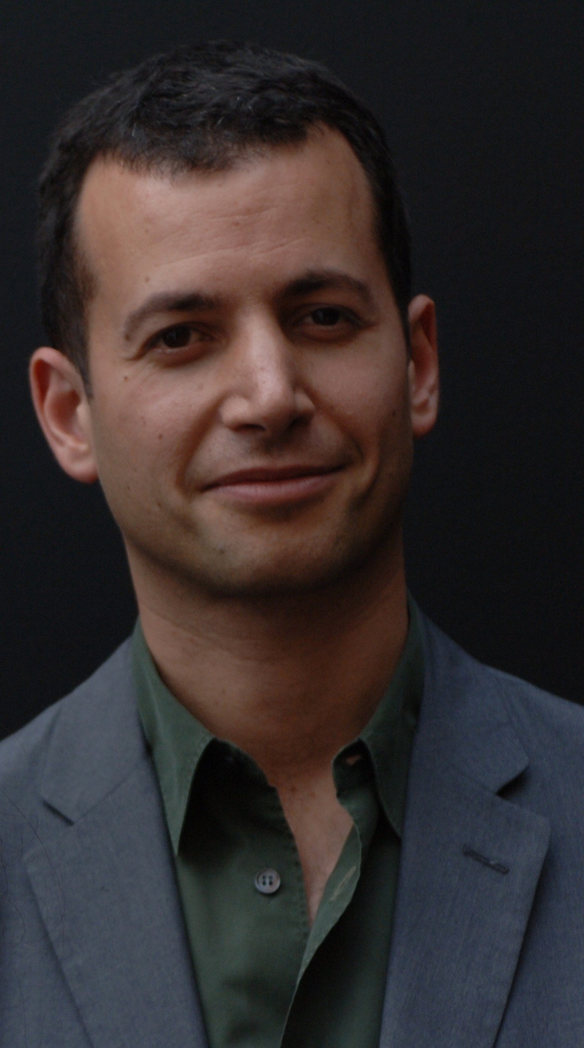 Portrait of Mathew Slotover, co-director of Frieze Art Fair, against a dark background.