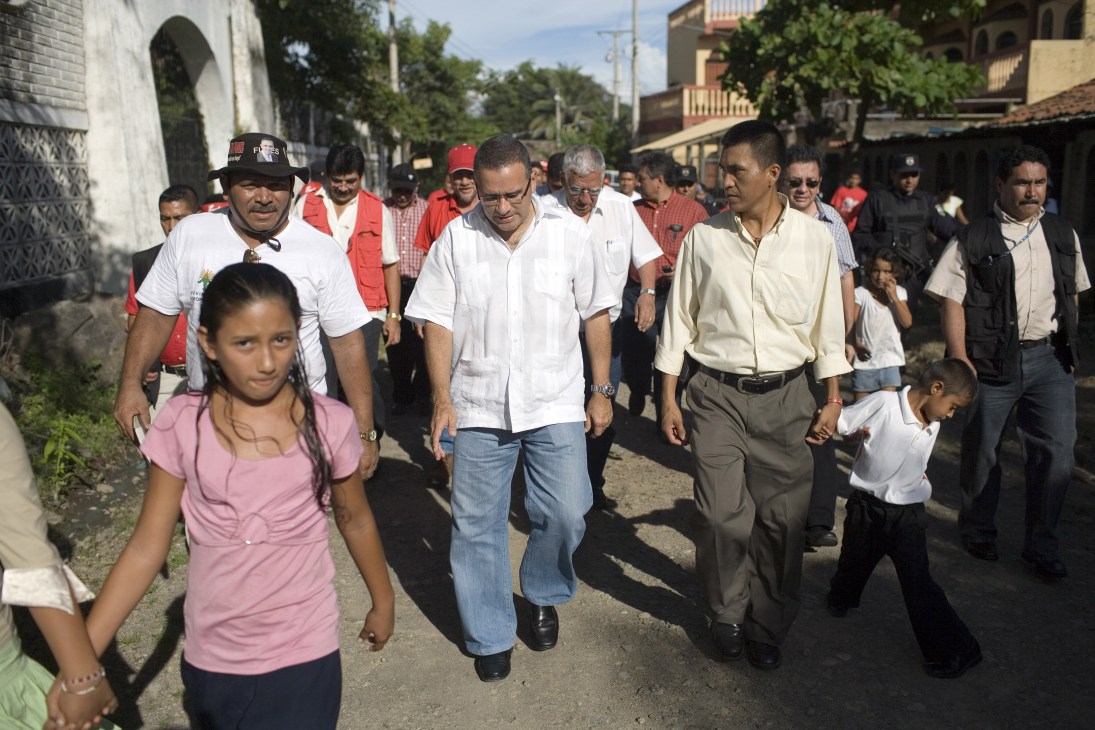 Mauricio Funes walks through a street with supporters and followers in El Salvador.