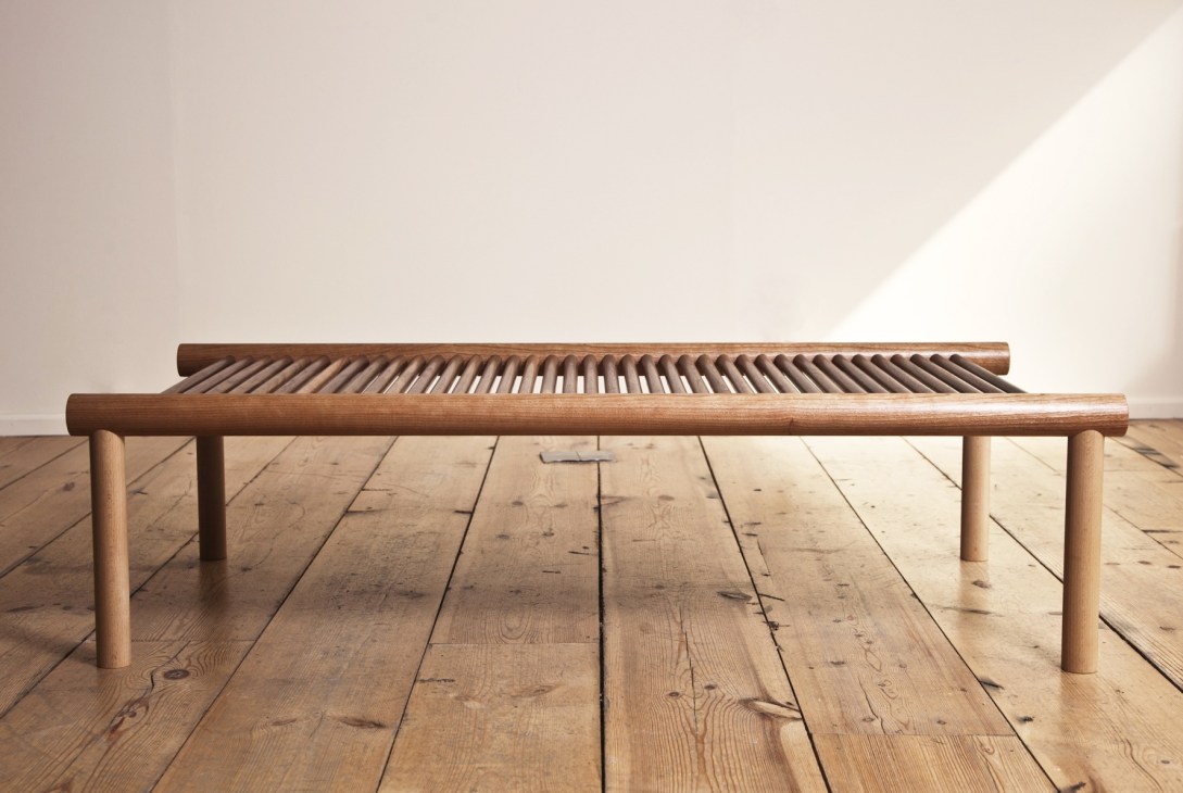 Handmade wooden coffee table with cylindrical dowel details and turned legs by Max Lamb for Woodware.
