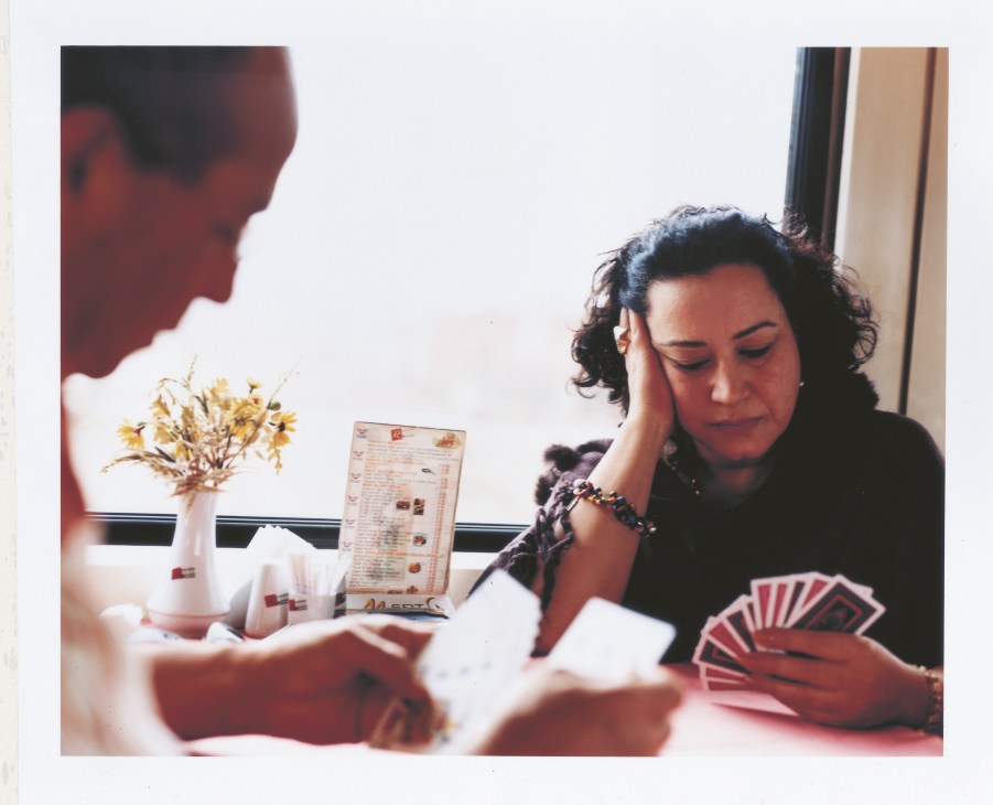 Ladan Jahansouz plays Rummy with the train's chef in the dining car.
