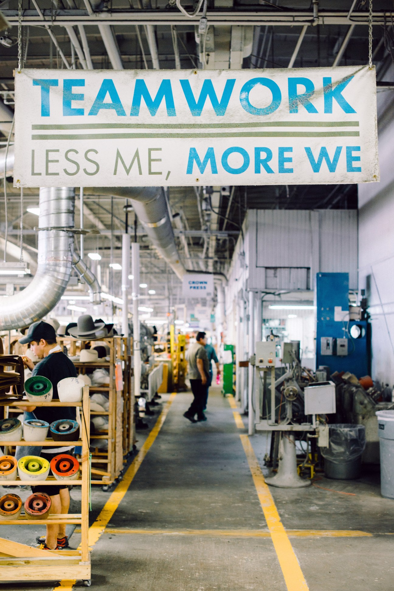 Factory workers collaborate on a production line in an industrial manufacturing facility.