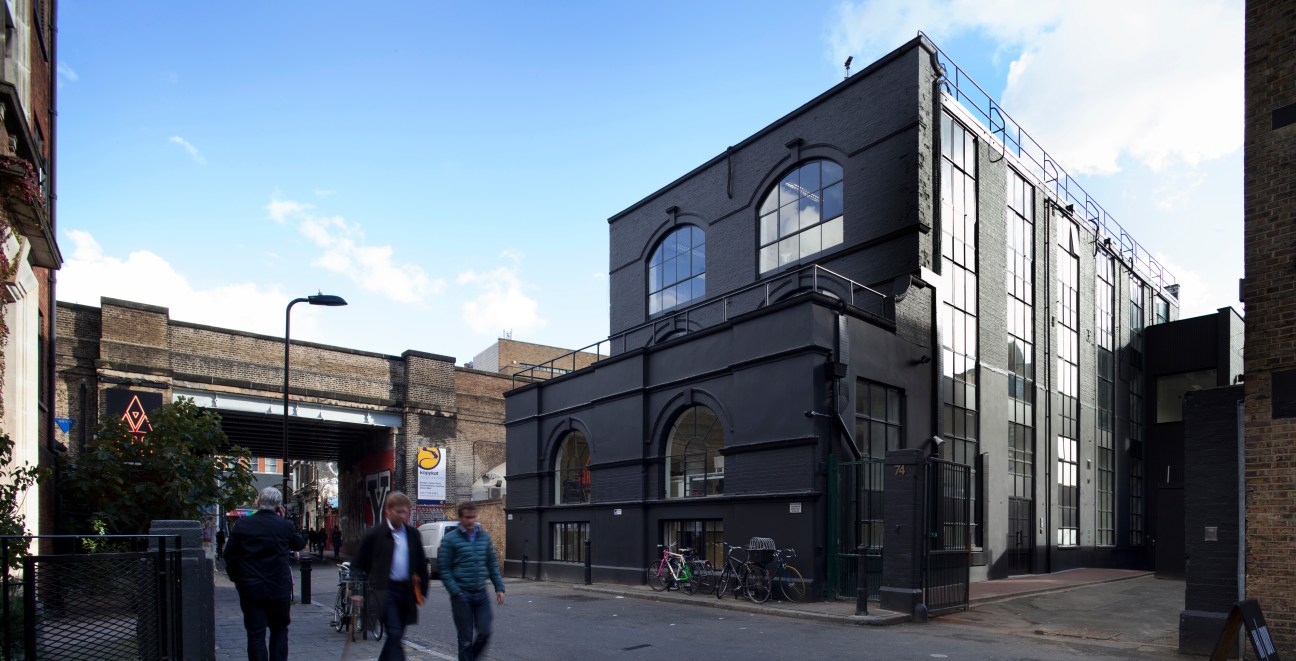 The Black & White Building in east London, a converted factory with modern office spaces and large windows.