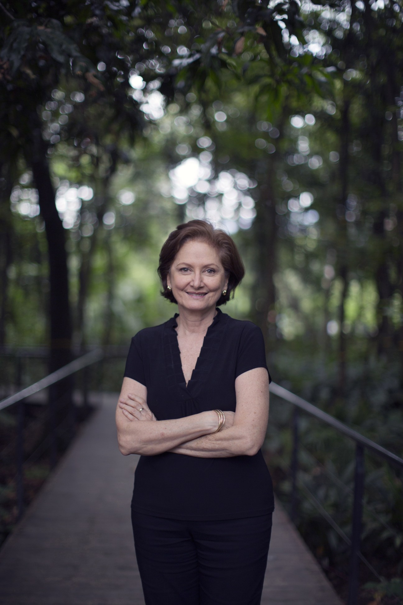 Pillar Velilla, former head of the city's botanical gardens, poses in a forest setting.