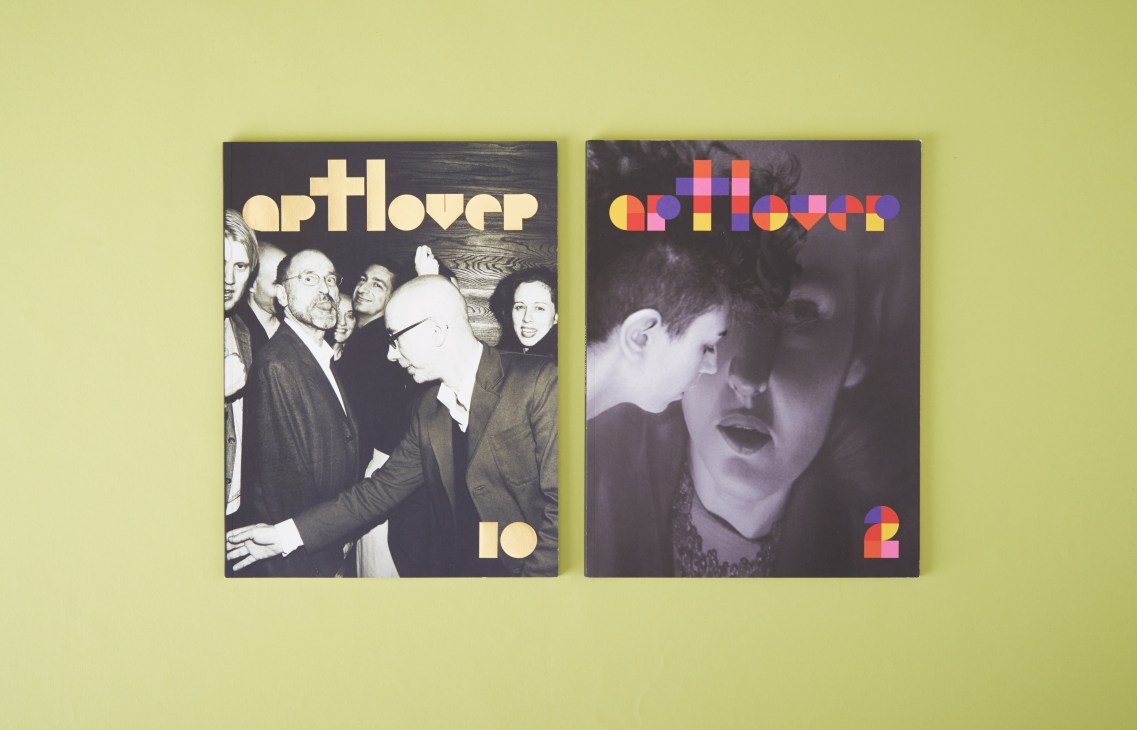 Two issues of Artlover magazine displayed on a yellow background featuring bold typography and black and white photography.