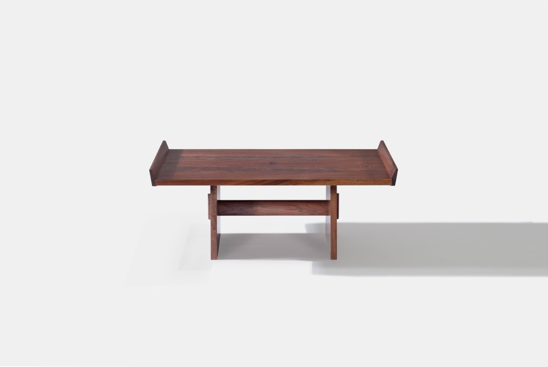Milk House table by George Nakashima, a wooden bench-style table with raised sides and a lower shelf