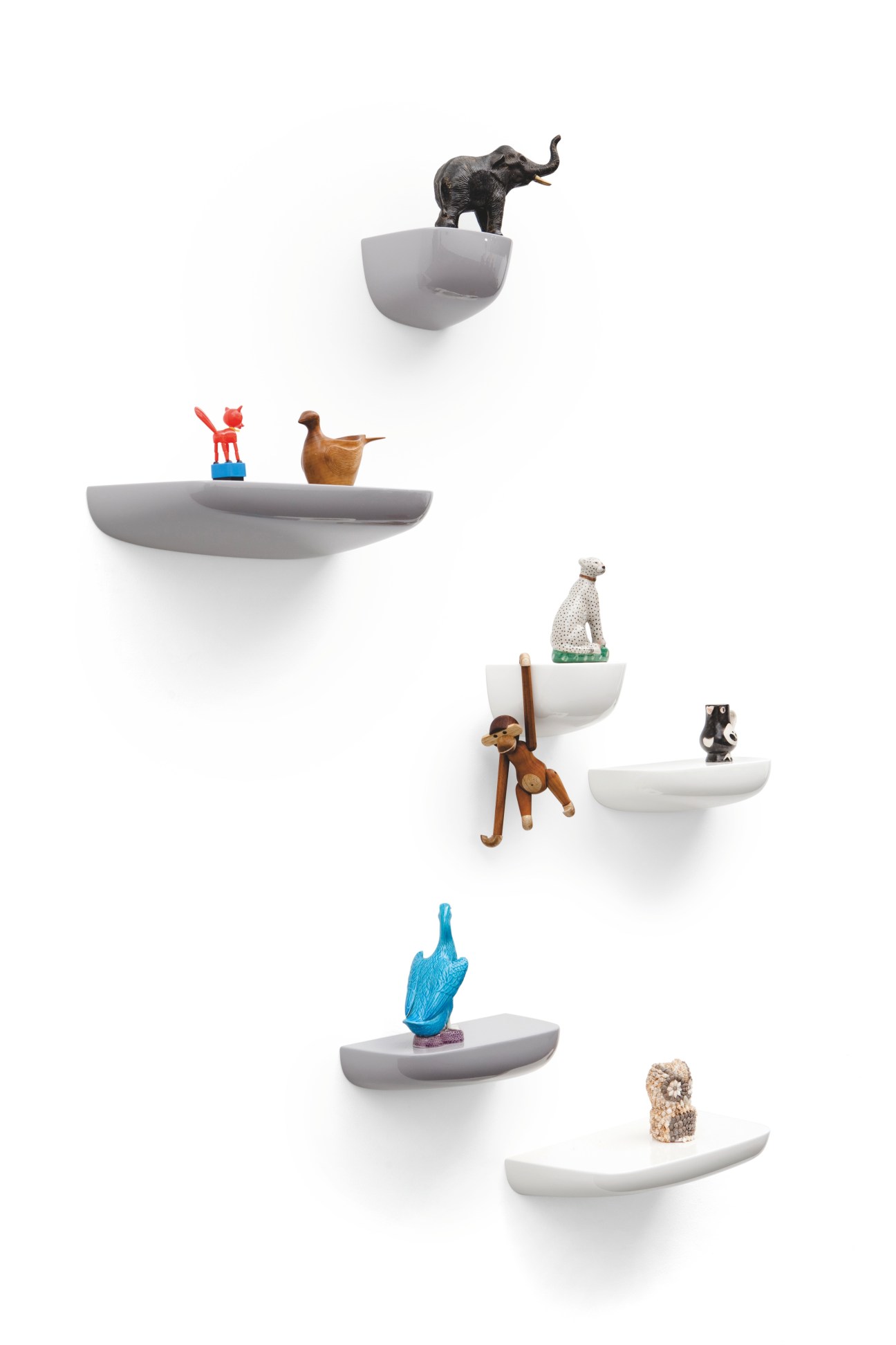 Vitra mini podium shelves by the Bouroullec brothers displaying decorative objects including animal figurines and sculptures.