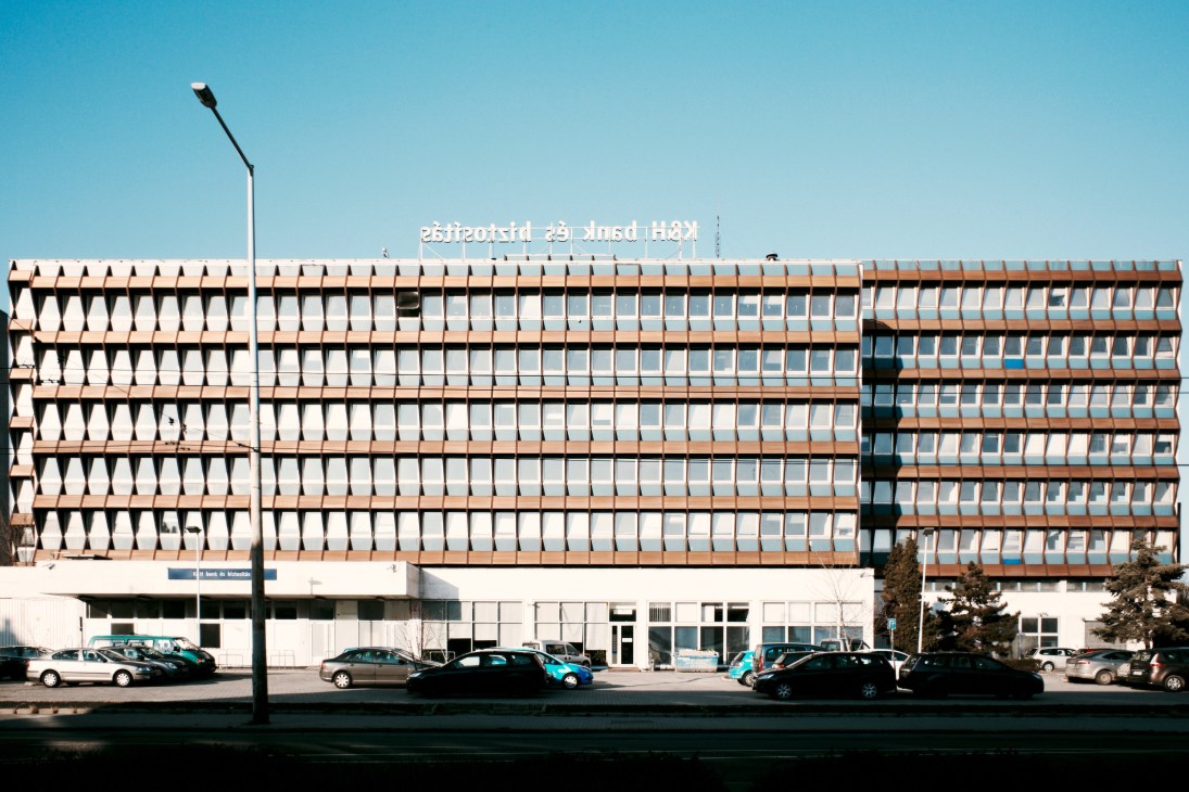 Modernist apartment building with repetitive window pattern and signage in Budapest's District XIII.