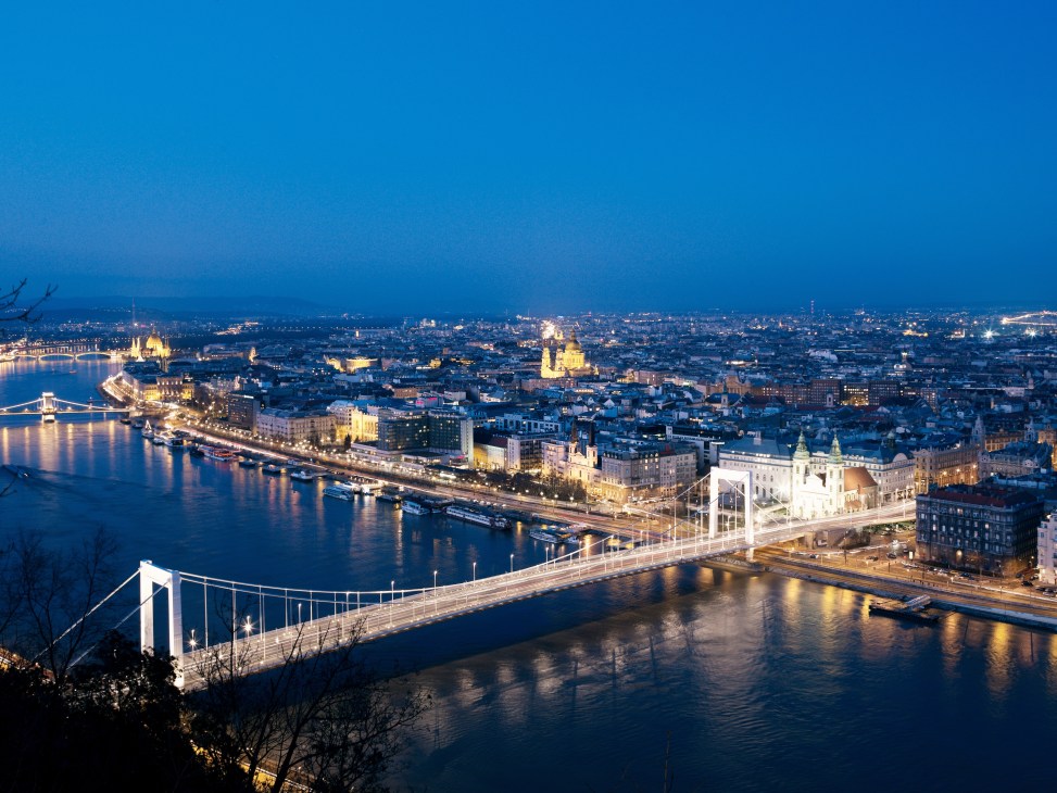 Evening view of Budapest's illuminated skyline with Erzsebet Bridge spanning the Danube River.
