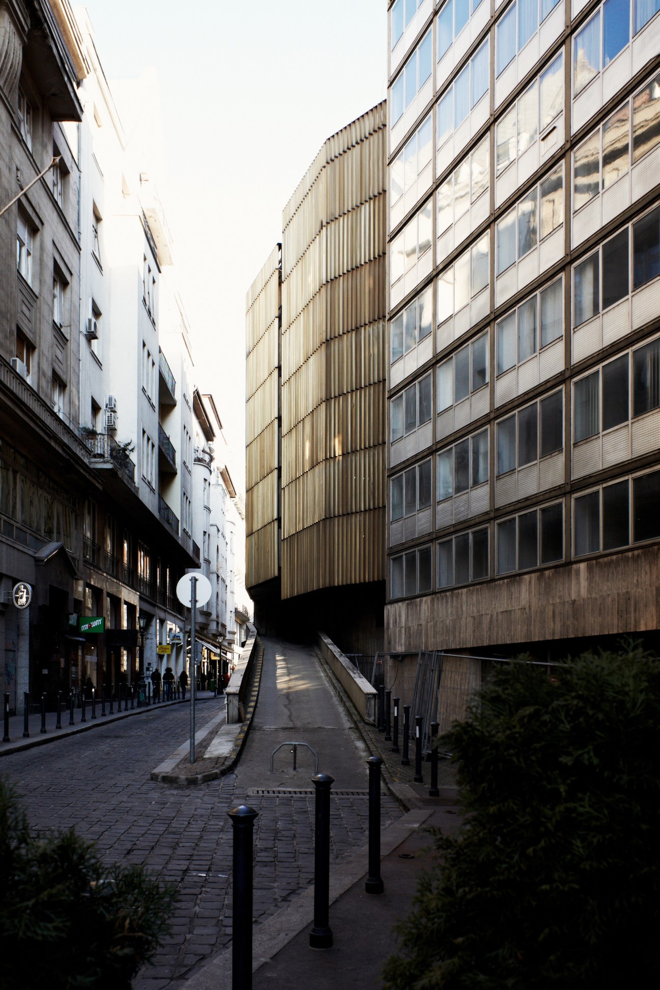 Modern and Art Deco buildings line a pedestrian street in Budapest's District XIII.