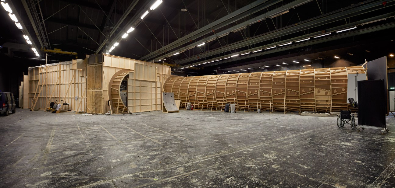 Wooden replica of a subway train car and station interior on a soundstage set.