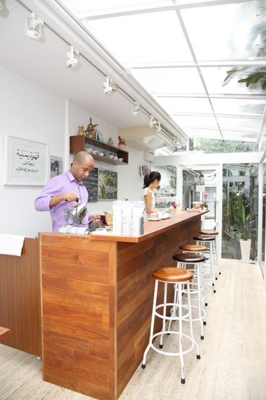 Hussein Ahmed stands behind the wooden counter at Mocha Coffee in Tokyo's Daikanyama district.