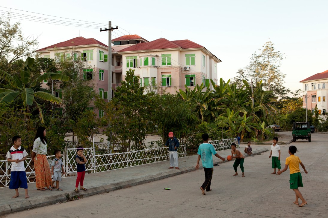 Children play in a street in front of pink apartment buildings in Lal Way district, Naypyidaw.
