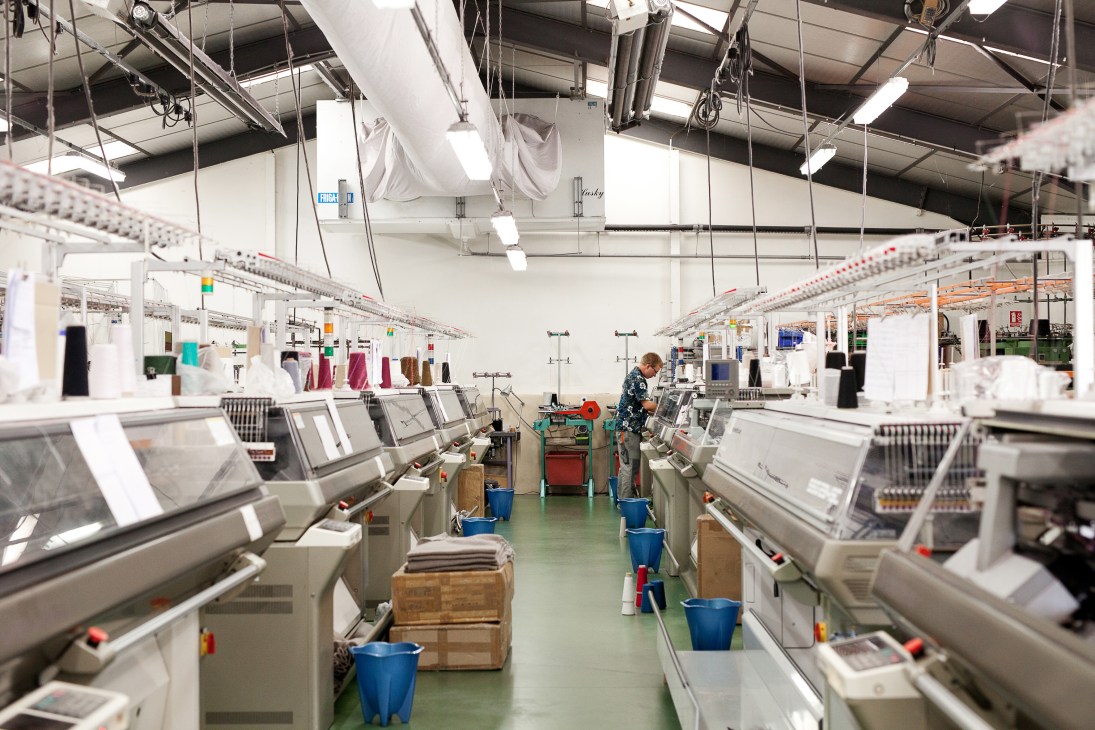 Interior of Molli factory in Saint Étienne with industrial machinery and a worker on the production floor.