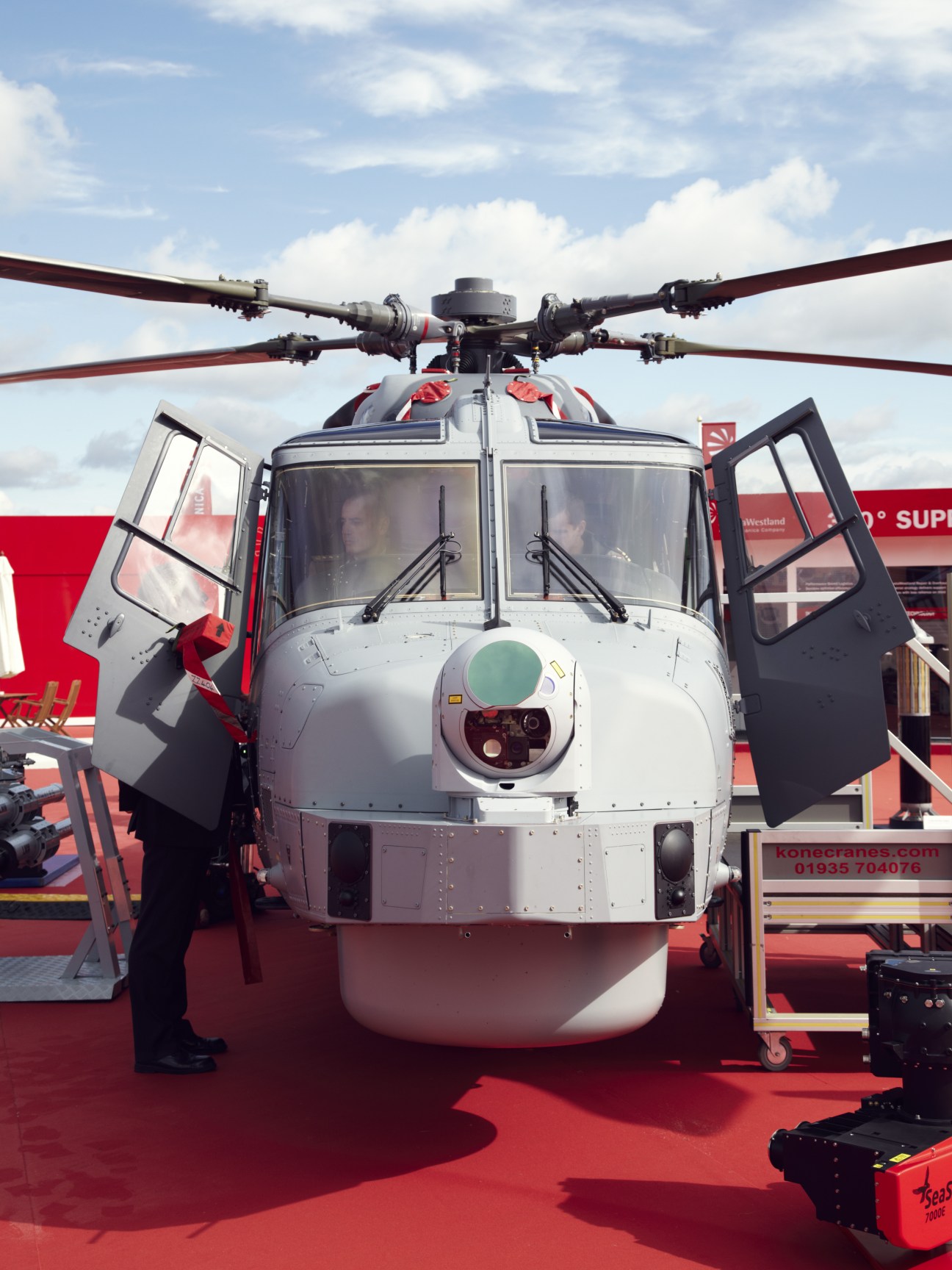 AgustaWestland AW159 Wildcat helicopter displayed front-on with rotor blades extended and cabin doors open.