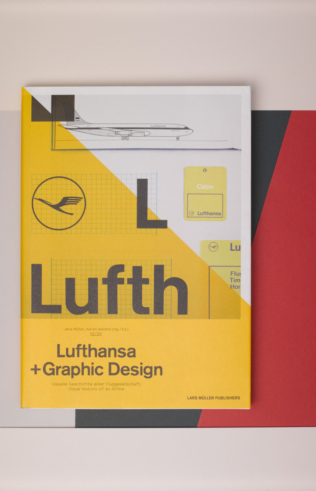 Lufthansa + Graphic Design book cover featuring yellow, black and red design with aircraft and crane logo.