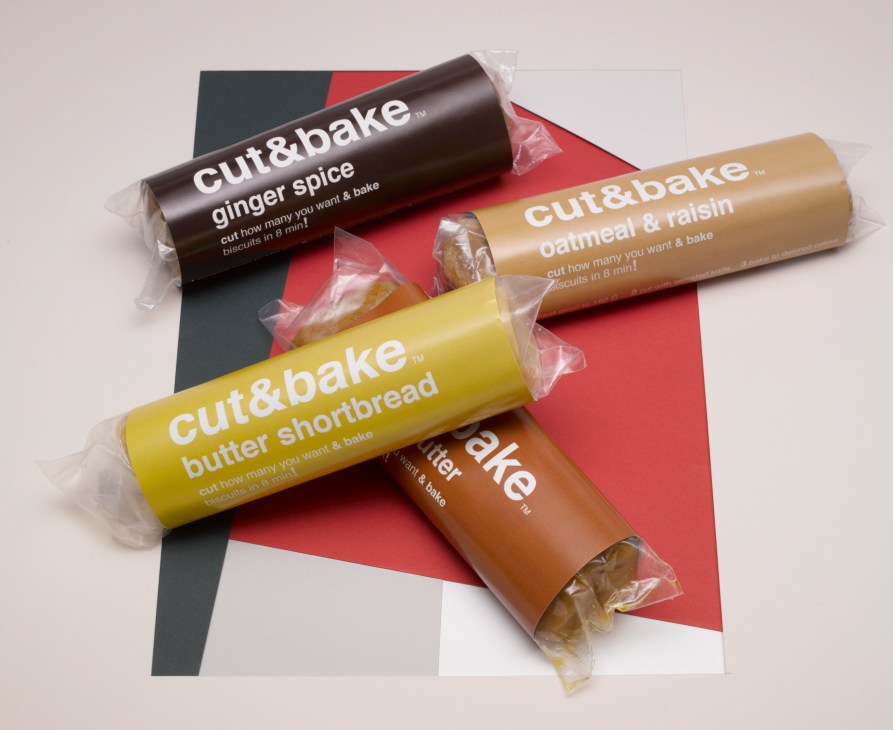 Cut&Bake cookie dough rolls in ginger spice, oatmeal & raisin, and butter shortbread flavors displayed on red and white paper.
