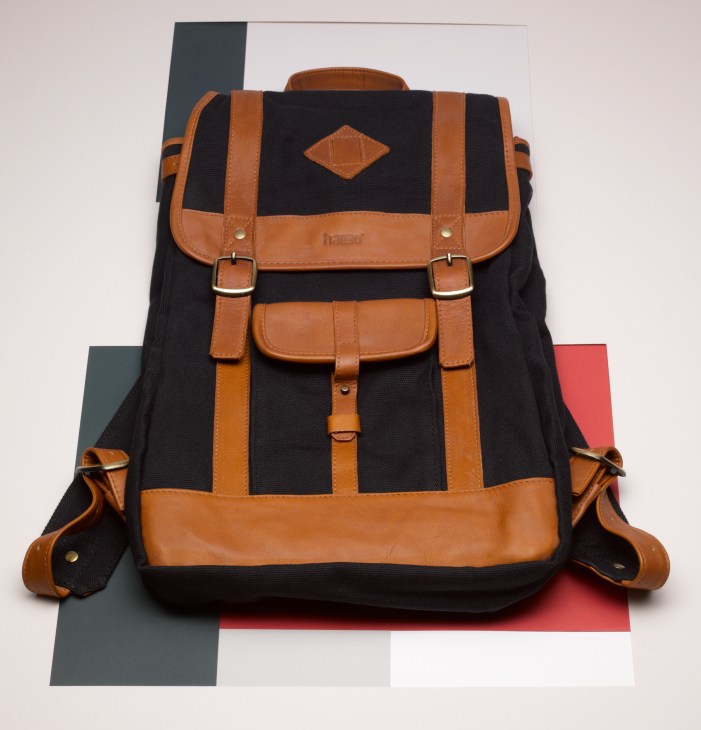 Hasso black canvas and tan leather backpack with front pockets and straps.