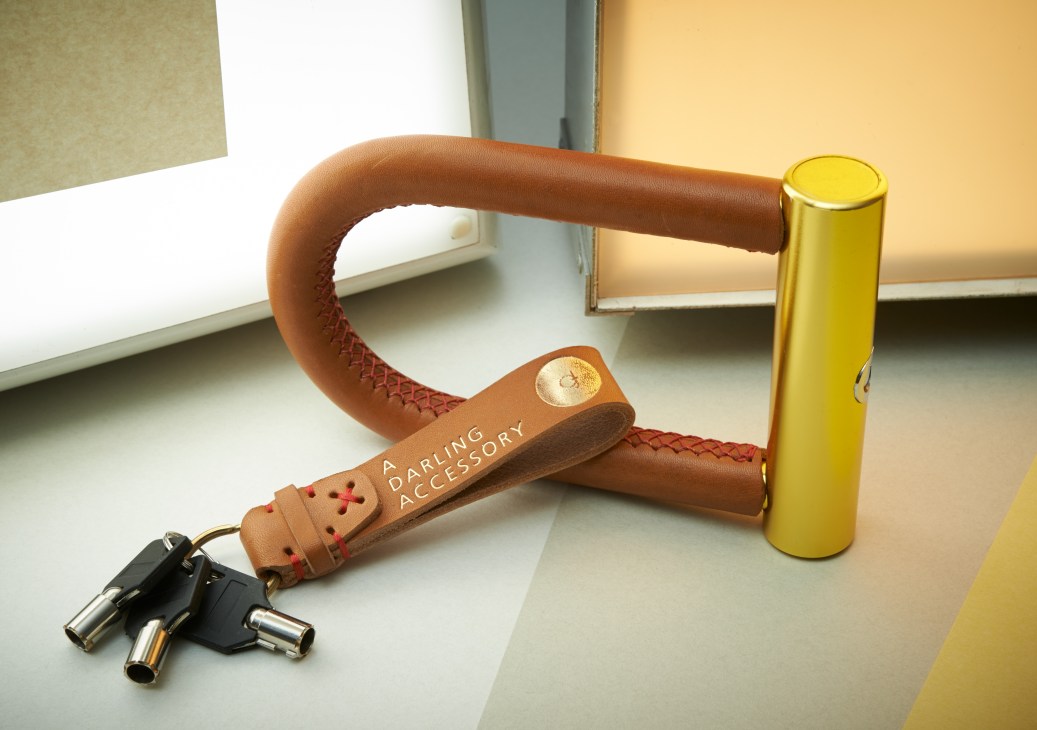 Deutsche & Japaner leather bike lock and key ring with red stitching and gold foil finish.
