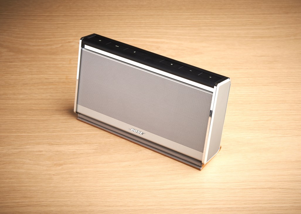 Bose SoundLink Bluetooth Mobile II wireless speaker in white with black top panel on wooden surface.
