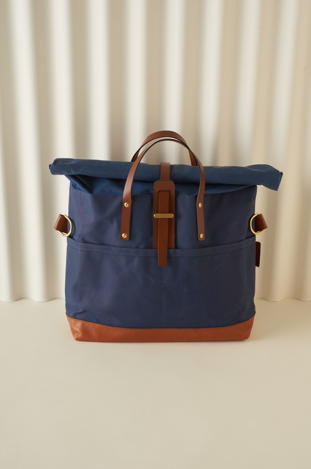 Navy canvas roll-top tote bag with brown leather handles and base by Tailfeather.