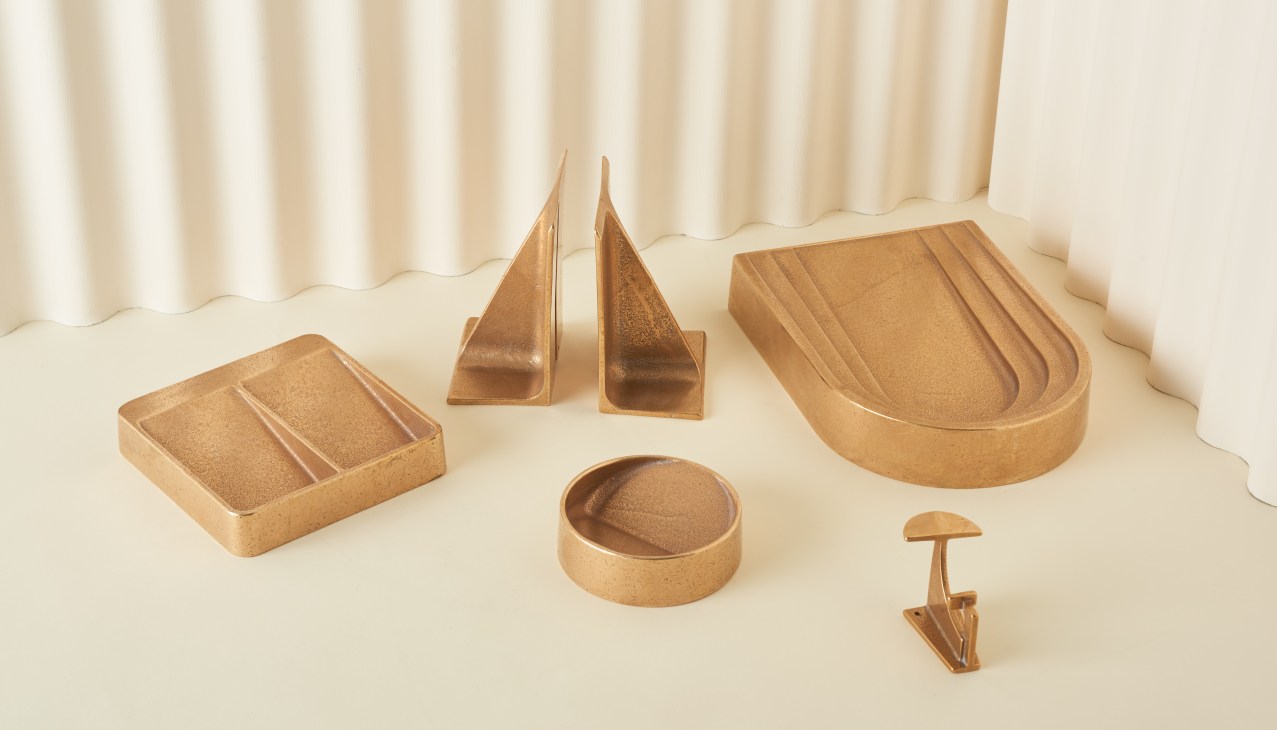 Brass desktop accessories including vide poche dishes, bookends and a Thoronet dish by Henry Wilson.