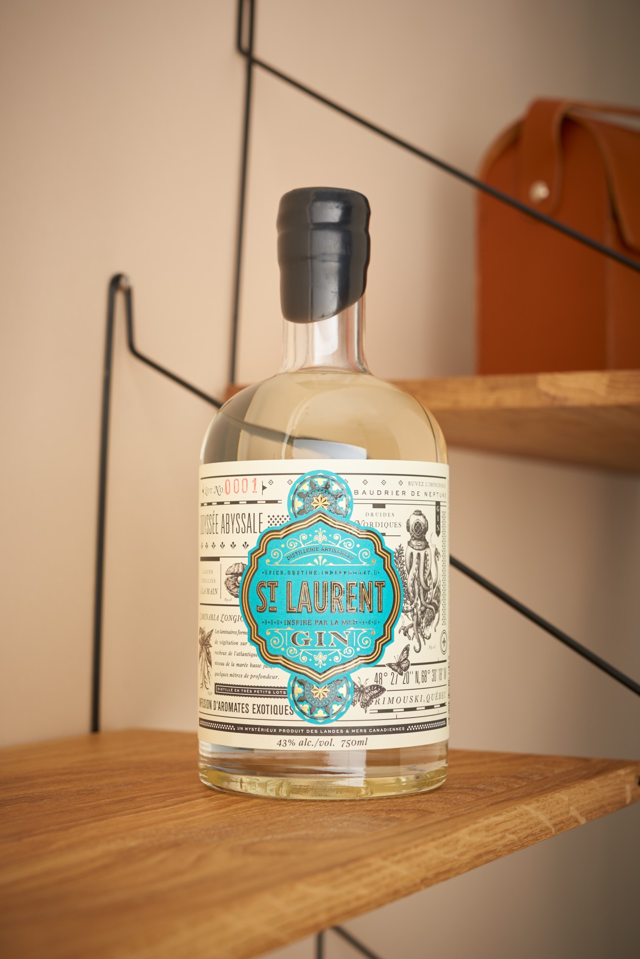 St Laurent gin bottle with turquoise label on wooden table