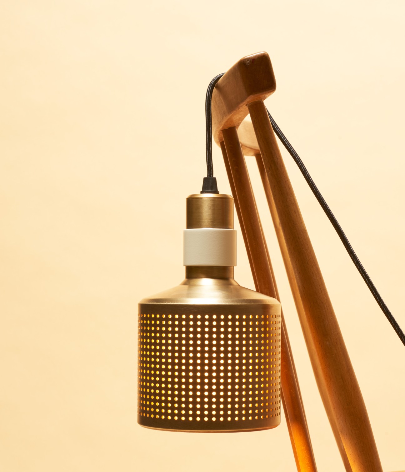 Brass pendant lamp with perforated shade and wooden tripod stand by Bert Frank