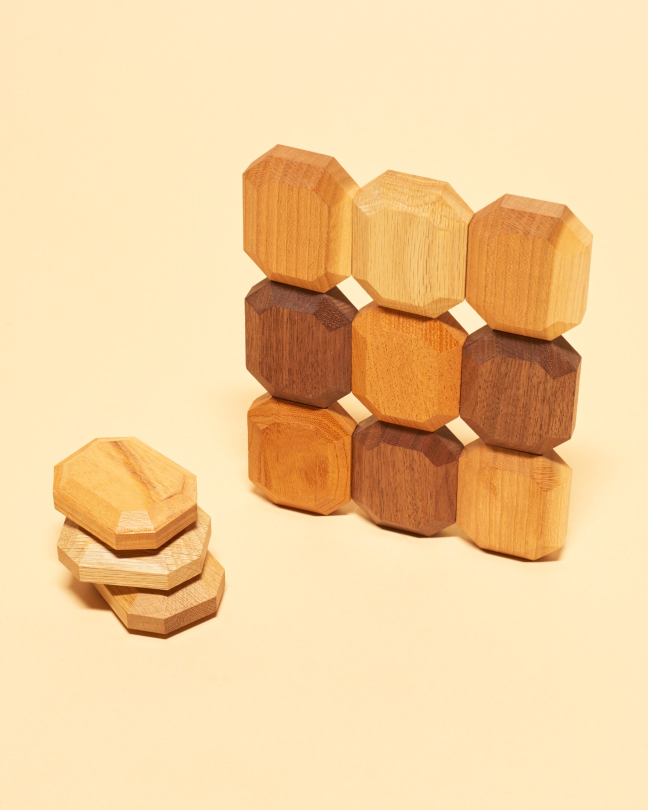 Wooden building blocks by Twoodie in natural wood tones arranged in a pyramid and stacked formation.