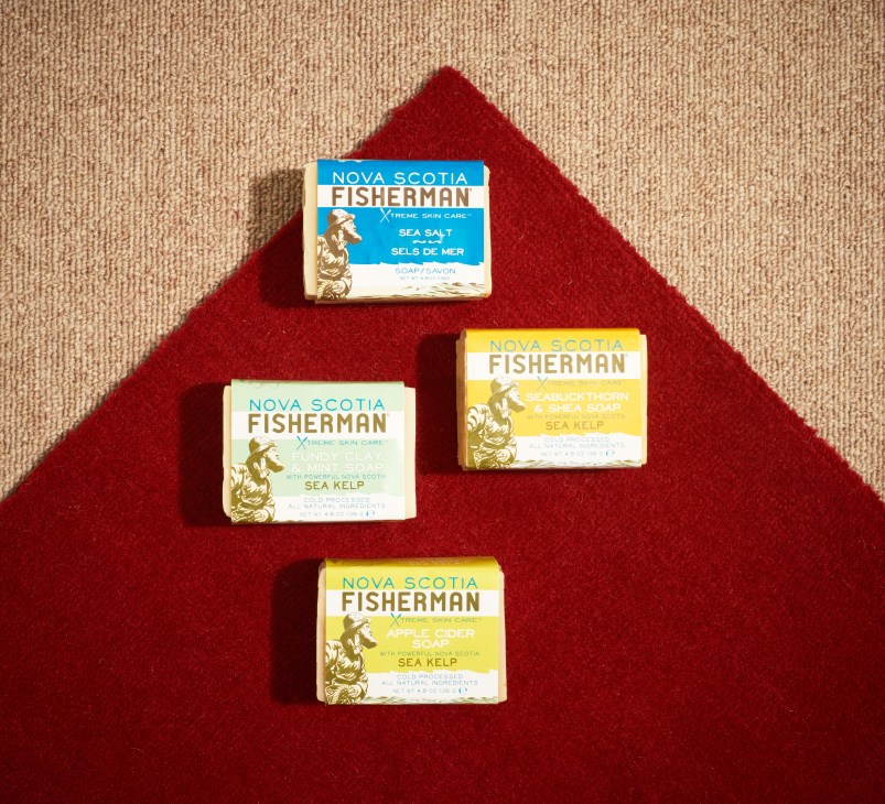 Four Nova Scotia Fisherman soap bars arranged on red fabric background