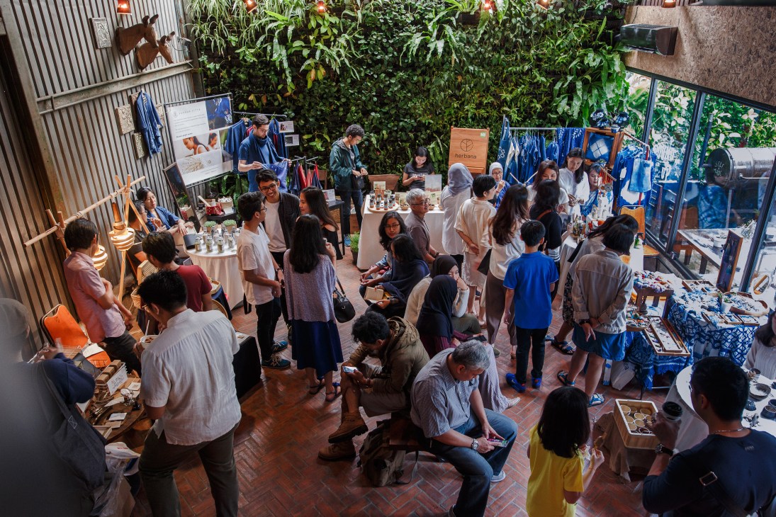 Overhead view of Indoestri's open-air courtyard during an event with visitors browsing local designer products and displays.
