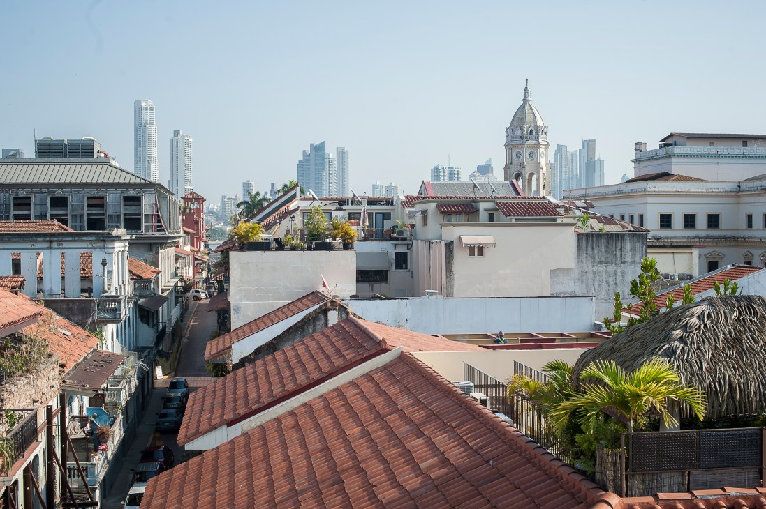 Casco Viejo rooftops with terracotta tiles and colonial architecture overlooking modern Panama City skyline.