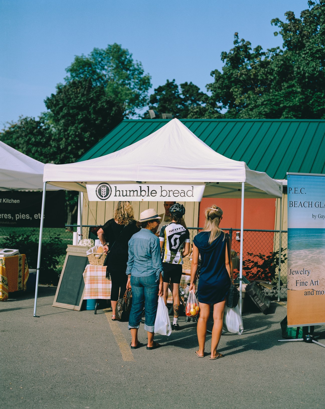 People queue at Humble Bread tent stall at Wellington Farmers' Market