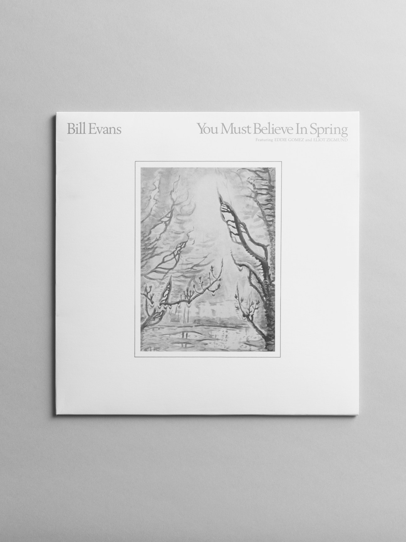 Bill Evans album cover 'You Must Believe In Spring' with black and white artwork showing trees and landscape