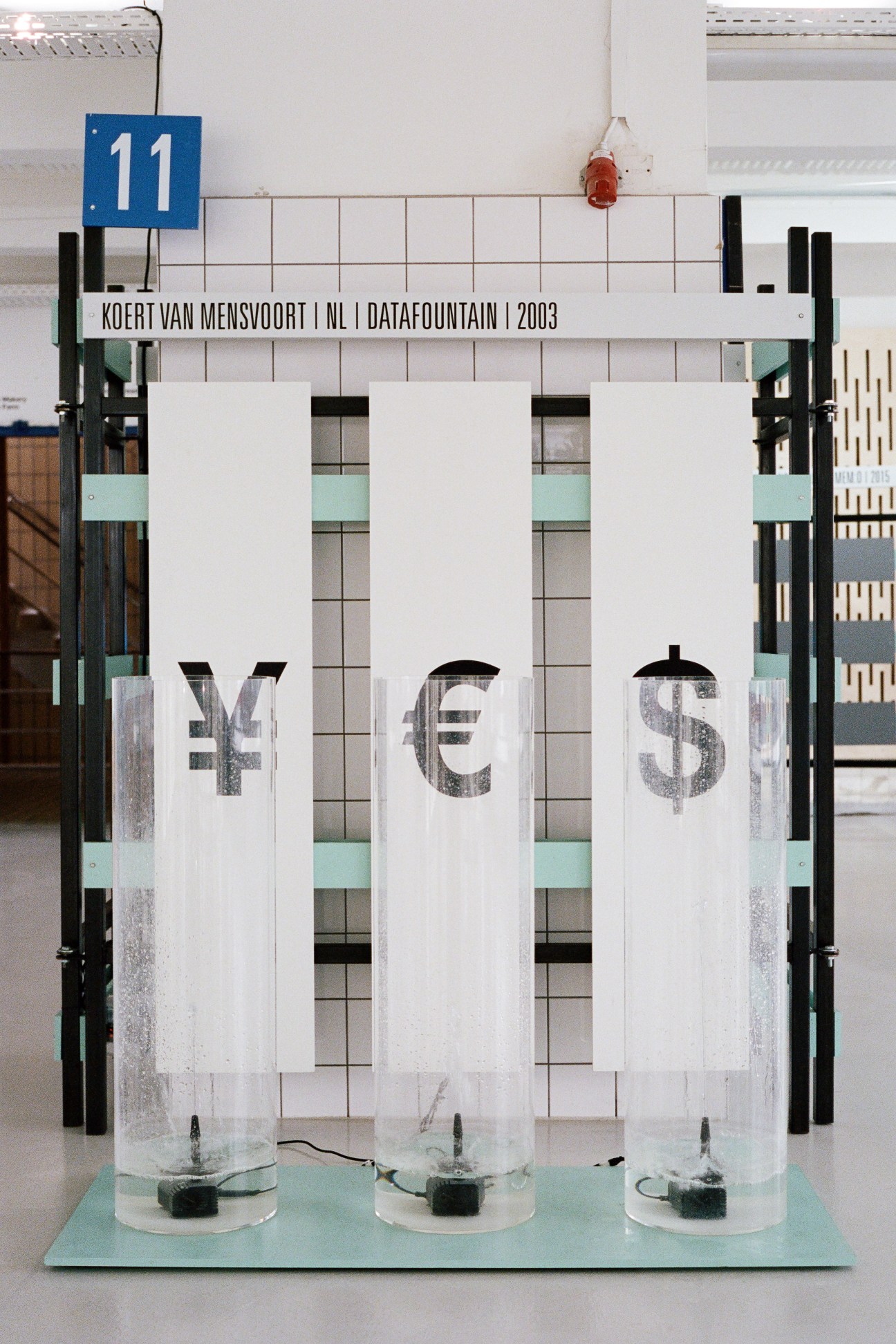 The Datafountain installation displaying currency symbols with water fountains at Space10.
