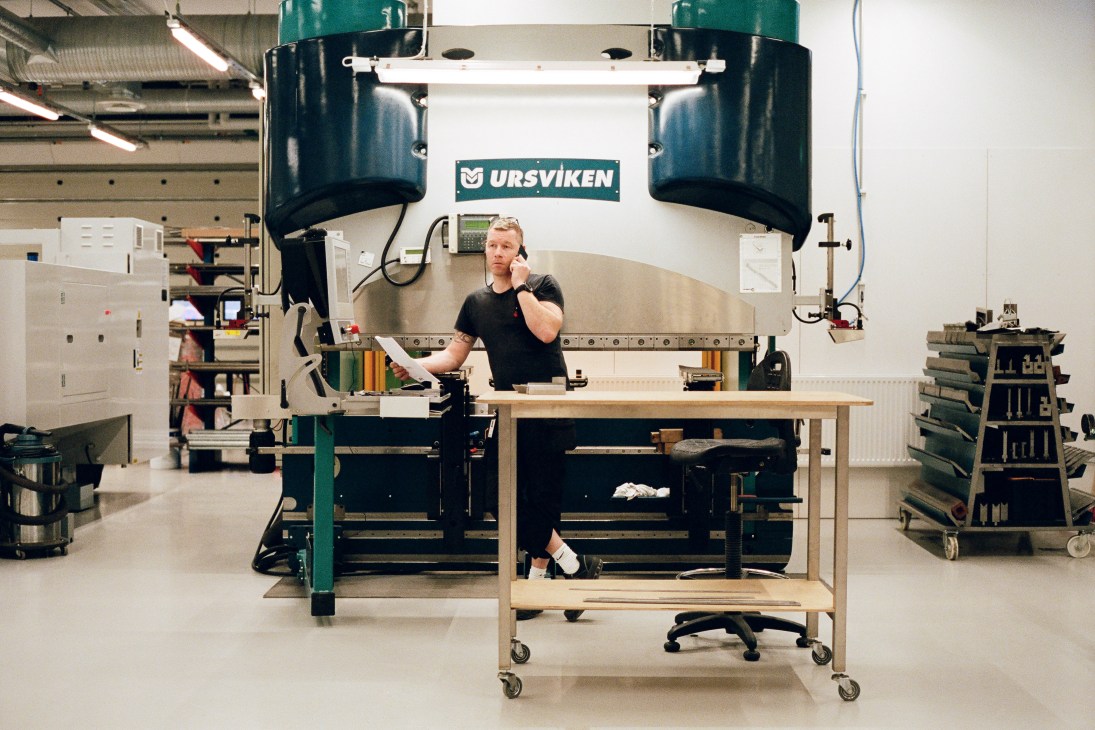 Metal specialist working at a large industrial press machine in Ikea's prototype department workshop.